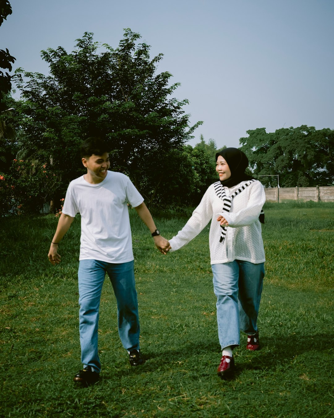 celebrity couple walking in park