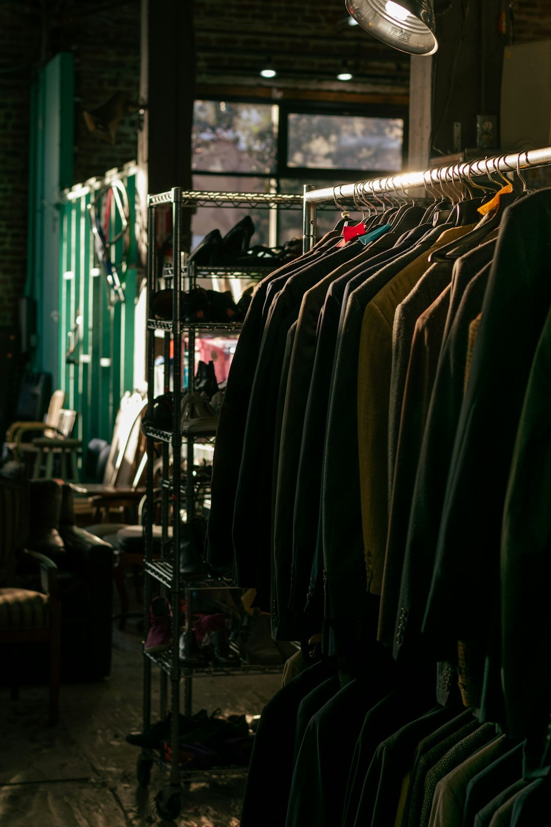 Vintage designer wardrobe with tailored garments on hangers